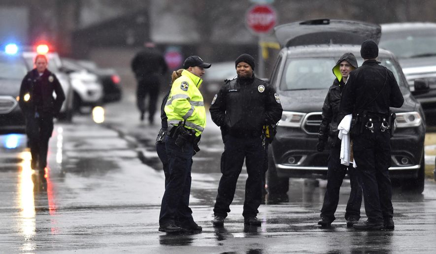 Louisville Metro Police officer's await the arrival of crime scene investigators following a deadly shooting in which a police officer was injured on Thursday, Feb. 1, 2018, in Louisville, Ky. Louisville Metro Council President David James, a former police officer, said Thursday that he was told by officers that the wounded officer is expected to be OK. He had no details about the circumstances. Louisville police did not immediately release a statement. (AP Photo/Timothy D. Easley), Thursday, Feb. 1, 2018, in Louisville, Ky. (AP Photo/Timothy D. Easley)