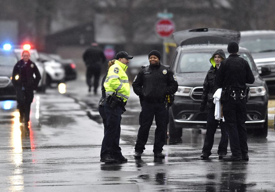 Louisville Metro Police officer's await the arrival of crime scene investigators following a deadly shooting in which a police officer was injured on Thursday, Feb. 1, 2018, in Louisville, Ky. Louisville Metro Council President David James, a former police officer, said Thursday that he was told by officers that the wounded officer is expected to be OK. He had no details about the circumstances. Louisville police did not immediately release a statement. (AP Photo/Timothy D. Easley), Thursday, Feb. 1, 2018, in Louisville, Ky. (AP Photo/Timothy D. Easley)
