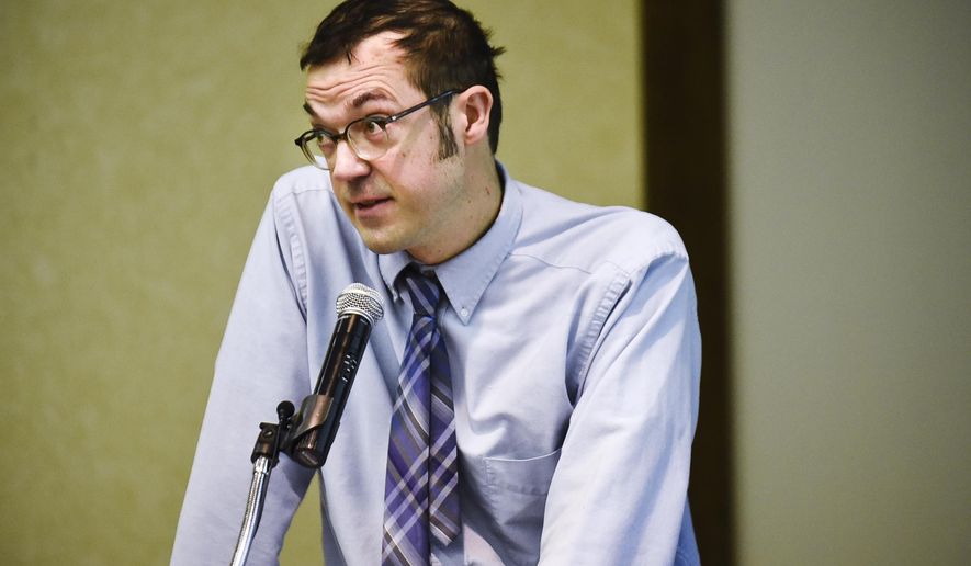 Tom Bourguignon, a foster parent, speaks in opposition Thursday, Feb. 1, 2018, during a hearing on the administrative rules to change Medicaid reimbursements and service eliminations at the Department of Health and Human Service in Helena, Mont. (Thom Bridge/Independent Record via AP)