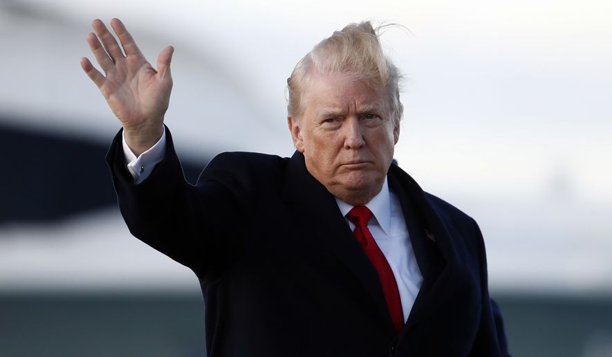President Donald Trump waves as he walks from Marine One to board Air Force One, Friday, Feb. 2, 2018, in Andrews Air Force Base, Md., en route to Palm Beach International Airport, in West Palm Beach, Fla. (AP Photo/Carolyn Kaster)