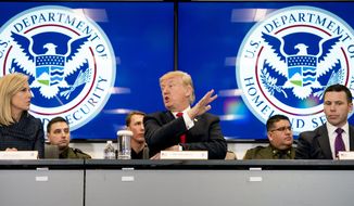 In this file photo, President Donald Trump, accompanied by Homeland Security Secretary Kirstjen Nielsen, left, and U.S. Customs and Border Protection Acting Commissioner Kevin McAleenan, right, speaks during a roundtable at the Customs and Border Protection National Targeting Center in Reston, Va., Friday, Feb. 2, 2018. (AP Photo/Andrew Harnik) **FILE**
