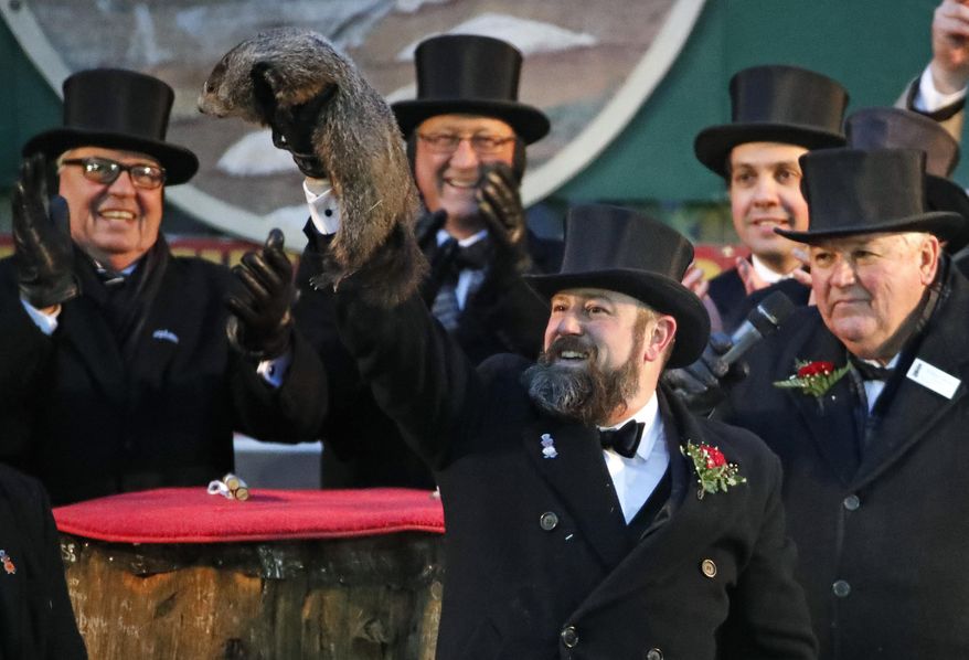 Groundhog Club co-handler Al Dereume holds Punxsutawney Phil, the weather prognosticating groundhog, during the 132nd celebration of Groundhog Day on Gobbler's Knob in Punxsutawney, Pa. Friday, Feb. 2, 2018. Phil's handlers said that the groundhog has forecast six more weeks of winter weather. (AP Photo/Gene J. Puskar)