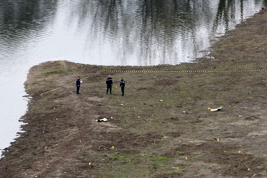 Investigators work at the site where two French military training helicopters collided and crashed in a wooded area of Provence, killing five people aboard, Friday, Feb.2, 2018. A spokeswoman for the French army said the helicopters came from the army's light aviation school based in nearby Le-Cannet-des-Maures. (AP Photo/Claude Paris)