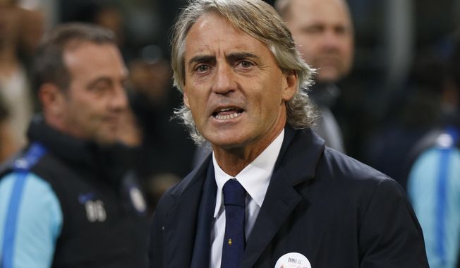 FILE - In this Oct. 18, 2015 file photo Inter Milan coach Roberto Mancini waits for the start of a Serie A soccer match between Inter Milan and Juventus at the San Siro stadium in Milan, Italy. The Italian soccer federation has talked to Roberto Mancini about the possibility of becoming the next coach of the national team. The 53-year-old Mancini, who has coached Manchester City and Inter Milan, is among several candidates for the role — along with current Chelsea coach Antonio Conte, Carlo Ancelotti and Claudio Ranieri. (AP Photo/Luca Bruno)