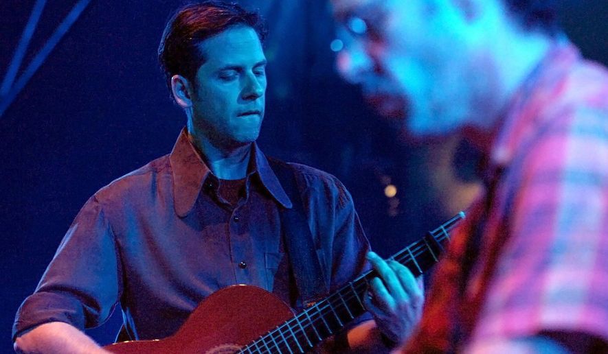 File-This July 24, 2007, file photo shows US musician Joey Burns and band Calexico, performing during the Blue Balls Festival in Lucerne, Switzerland. If the atomic scientists were listening to music when they recently moved the Doomsday Clock up to just two minutes to midnight, it may well have been Calexico’s “The Thread That Keeps Us.” Poignantly apocalyptic in places but with glimmers of hope and romance, the album would also be ideal for moving the hands of the clock a few minutes farther from disaster, hopefully soon. Now a septet, the Tucson-based Calexico recorded their ninth studio album in northern California and the change has done them good. Singer/guitarist Joey Burns says “there’s a little more chaos and noise in the mix” but, if anything, those elements help consolidate the harmony among the sounds. (AP Photo/Keystone, Sigi Tischler, File)