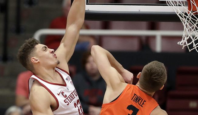 Stanford forward Reid Travis, left, shoots over Oregon State forward Tres Tinkle (3) during the first half of an NCAA college basketball game Thursday, Feb. 1, 2018, in Stanford, Calif. (AP Photo/Marcio Jose Sanchez)