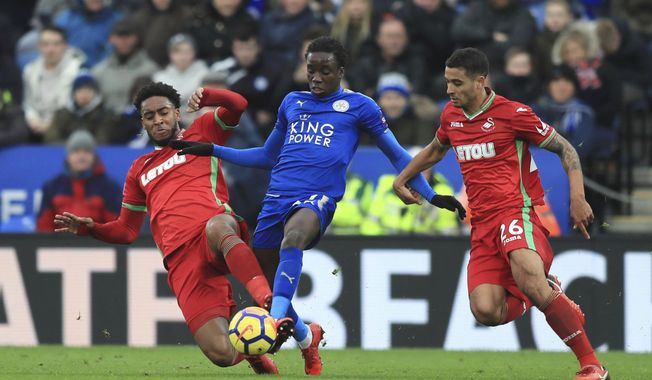 Swansea City&#x27;s Leroy Fer, left, and teammate Martin Olsson battle with Leicester City&#x27;s Fousseni Diabate, centre during the English Premier League soccer match between Leicester City and Swansea City, at the King Power Stadium, in Leicester, England, Saturday, Feb. 3, 2018. (Simon Cooper/PA via AP)