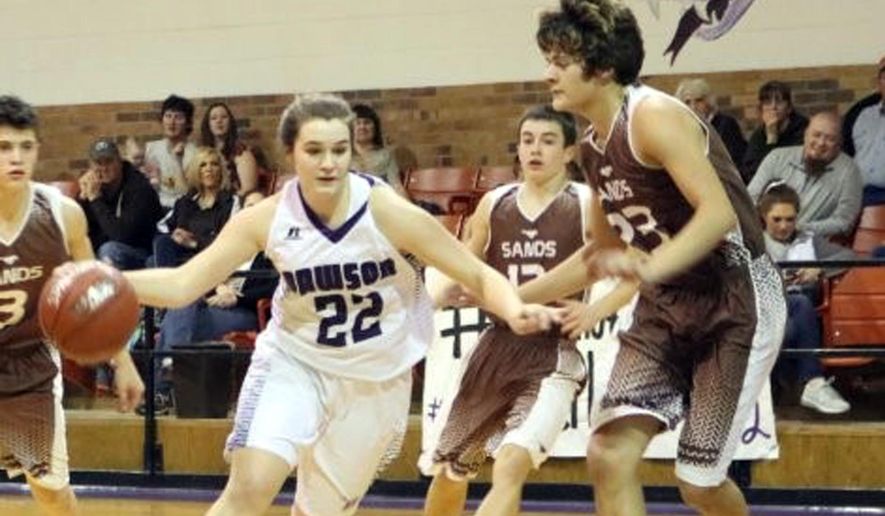 In this Friday, Jan. 26, 2018 photo, Dawson’s Murissa Horton (22) dribbles through several Sands defenders during a high school basketball game in Welch, Texas. At the smallest high school in Texas, injuries and dwindling enrollment forced the Dawson Dragons to consolidate the girls and boys basketball teams. The co-ed squad is playing a boys schedule. (AP Photo/Kristi Rieken)