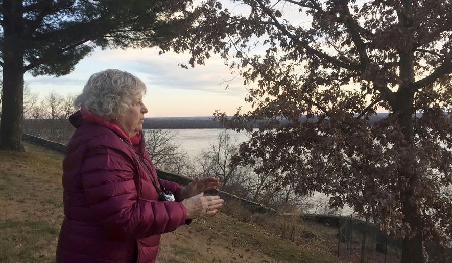 In a Dec. 5, 2017 photo, photographer Alice Tjaden scouts her camera position to take pictures of a sunrise on the Mississippi River, on a bluff in Burlington, Iowa. Tjaden has been taking photographs of the sunrise over the river almost every morning for the past five years. (Julia Mericle/The Hawk Eye via AP)