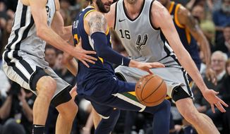 Utah Jazz&#39; Ricky Rubio, center, loses the ball as he is guarded by San Antonio Spurs&#39; Pau Gasol (16) and Manu Ginobili during the first half of an NBA basketball game, Saturday, Feb. 3, 2018, in San Antonio. (AP Photo/Darren Abate)