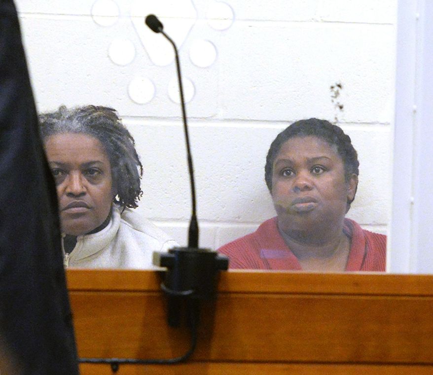 Rachel Hilaire and Peggy LaBossiere appear at Brockton District Court on on Wednesday, Feb. 1, 2018 in Bridgewater, Mass. The two sisters tied down and burned a 5-year-old girl, permanently disfiguring her, in a voodoo ritual meant to rid her of a demon causing her to misbehave, police said. The women also threatened to cut off the head of the unnamed girl's 8-year-old brother with a machete, authorities said. LaBossiere, 51, and Hilaire, 40, denied injuring the girl and threatening the boy and pleaded not guilty Monday, Jan. 29, to mayhem, assault and other charges. (Marc Vasconcellos/Enterprisenews.com via AP)