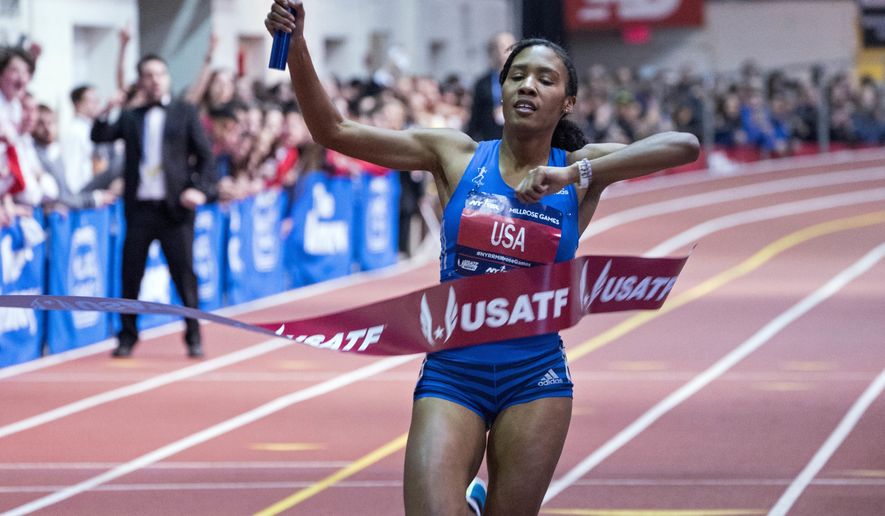 Ajee' Wilson breaks the tape as she and her team finished first in the Jack and Lewis Rudin Women's 4x800-meter relay race at the Millrose Games track and field meet in New York Saturday, Feb. 3, 2018. (AP Photo/Craig Ruttle)