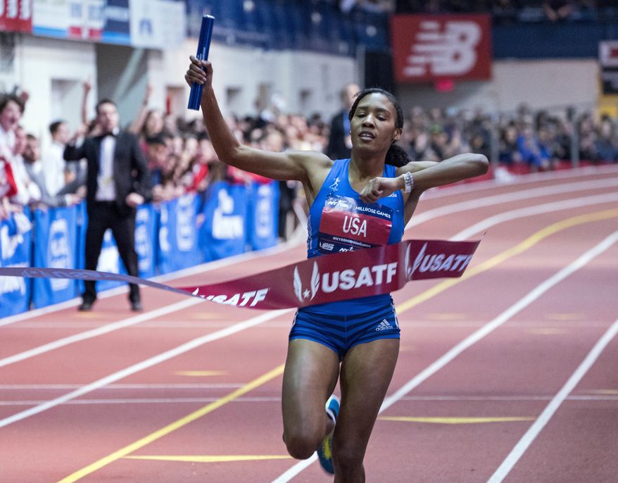 Ajee' Wilson breaks the tape as she and her team finished first in the Jack and Lewis Rudin Women's 4x800-meter relay race at the Millrose Games track and field meet in New York Saturday, Feb. 3, 2018. (AP Photo/Craig Ruttle)