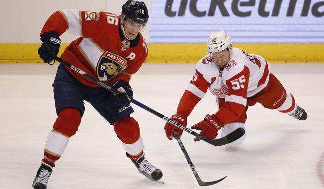 Florida Panthers center Aleksander Barkov (16) and Detroit Red Wings defenseman Niklas Kronwall (55) battle for the puck during the second period of an NHL hockey game, Saturday, Feb. 3, 2018 in Sunrise, Fla. (AP Photo/Wilfredo Lee)