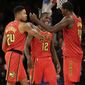 Atlanta Hawks&#39; Kent Bazemore, left, celebrates his three-point basket with Taurean Prince, center, and Dewayne Dedmon during the last seconds of the second half of an NBA basketball game against the New York Knicks, Sunday, Feb. 4, 2018, in New York. (AP Photo/Seth Wenig)