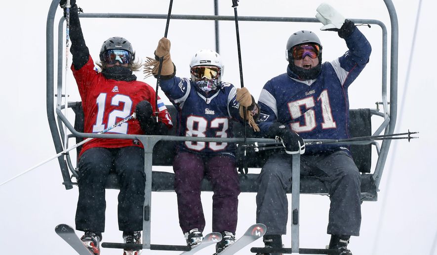 New England Patriots fans cheer as they ride the chairlift at Sugarloaf ski resort on Super Bowl Sunday, Feb. 4, 2018, in Carrabassett Valley, Maine. The resort is selling reduced-priced lift tickets to skiers wearing a New England Patriots jersey. (AP Photo/Robert F. Bukaty)