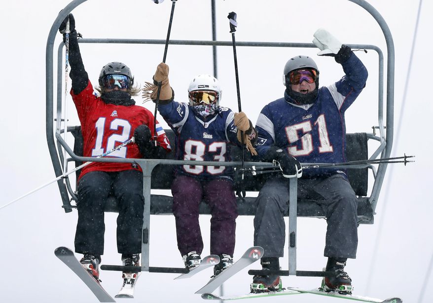 New England Patriots fans cheer as they ride the chairlift at Sugarloaf ski resort on Super Bowl Sunday, Feb. 4, 2018, in Carrabassett Valley, Maine. The resort is selling reduced-priced lift tickets to skiers wearing a New England Patriots jersey. (AP Photo/Robert F. Bukaty)