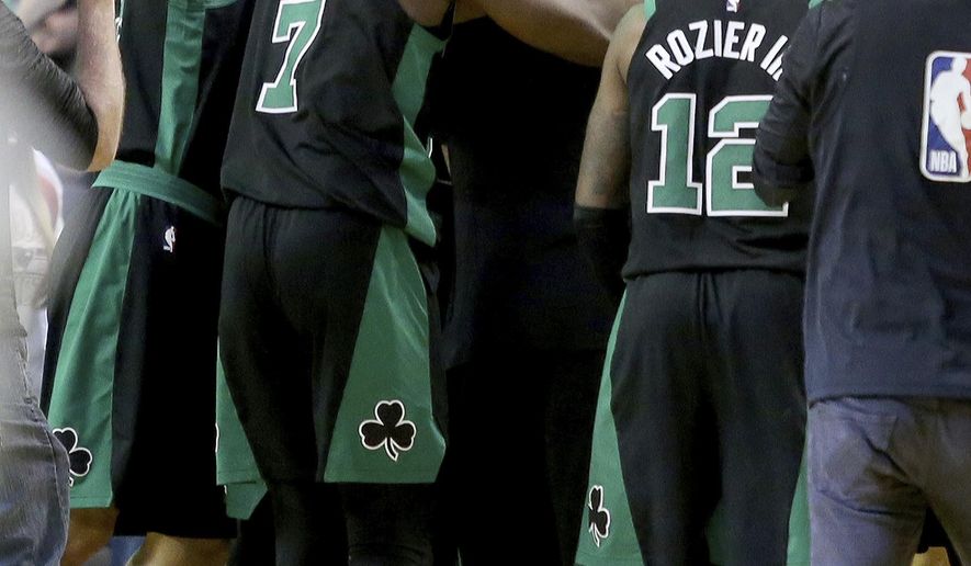 Boston Celtics players mob teammate Al Horford after he made the winning basket as time expired during an NBA basketball game against the Portland Trail Blazers, Sunday, Feb. 4, 2018, in Boston. (AP Photo/Mary Schwalm)
