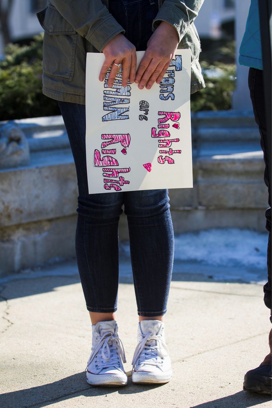 Researchers highlighted that the health risks associated with poor access for transgender and gender nonconforming youth are especially dangerous. They're less likely to seek help, the study said.
Emily Fishbaugh, a transgender teenager from North Hampton, holds a sign that reads "trans rights are human rights" during a rally in front of the Legislative Office Building in Concord ahead of a public hearing on a gender identity nondiscrimination bill on Wednesday, Jan. 31, 2018. (Elizabeth Frantz/Concord Monitor via AP)