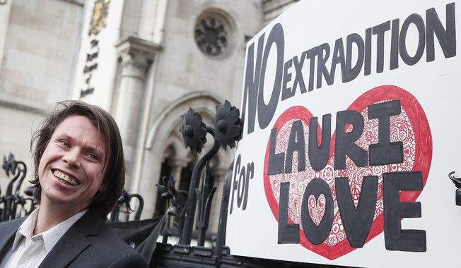 Lauri Love smiles outside The Royal Courts of Justice in London, Monday, Feb. 5, 2018. The ruling in Lauri Love&#x27;s appeal against extradition to the United States, where he faced solitary confinement and a potential 99 year prison sentence, was ruled in his favour on Monday Feb. 5 at the Royal Courts of Justice.(AP Photo/Kirsty Wigglesworth)