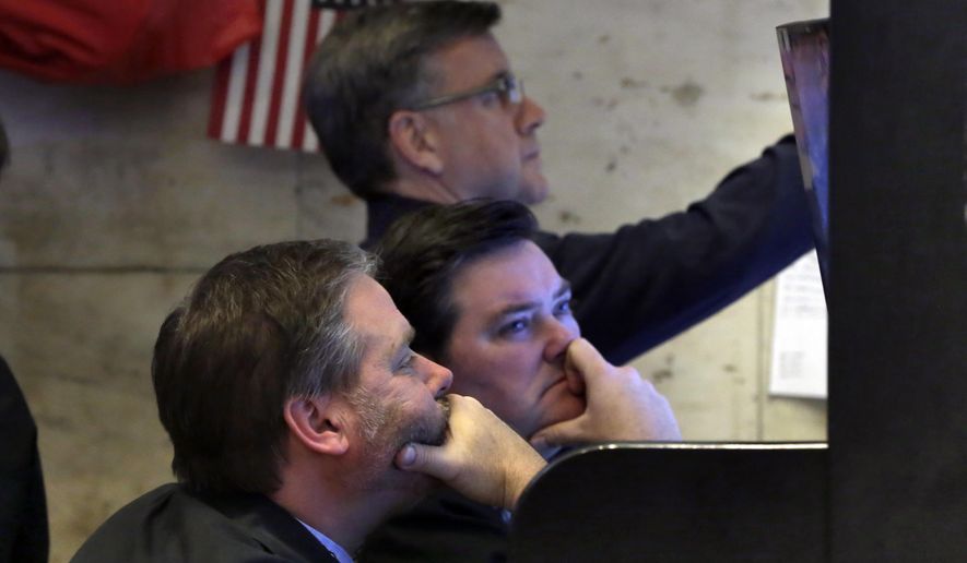 A trio of traders watch their screens in a booth on the floor of the New York Stock Exchange, Monday, Feb. 5, 2018. The Dow Jones industrial average plunged more than 1,100 points Monday as stocks took their worst loss in six and a half years. (AP Photo/Richard Drew)