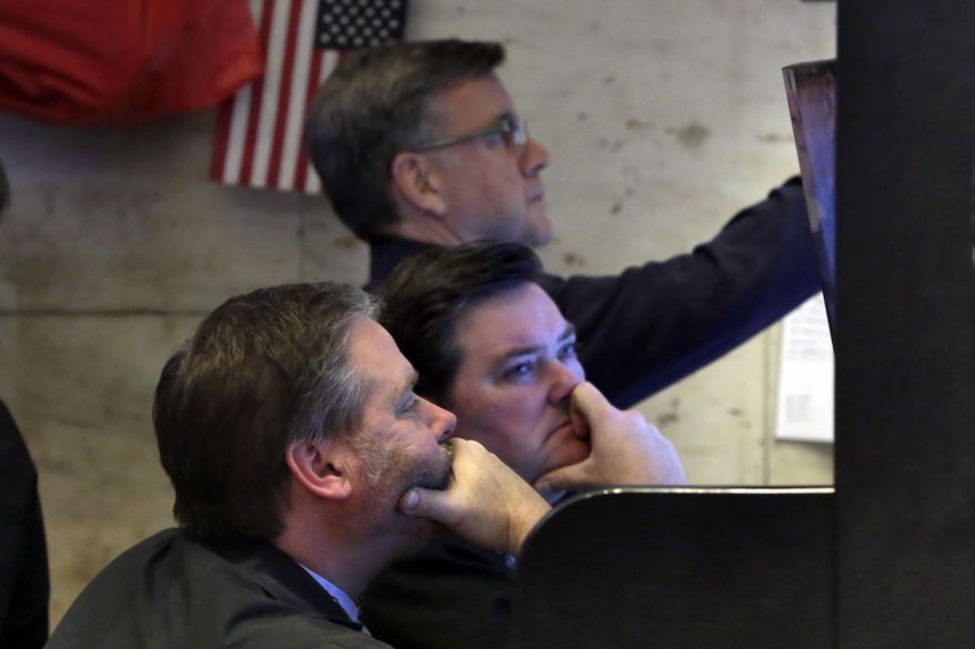 A trio of traders watch their screens in a booth on the floor of the New York Stock Exchange, Monday, Feb. 5, 2018. The Dow Jones industrial average plunged more than 1,100 points Monday as stocks took their worst loss in six and a half years. (AP Photo/Richard Drew)