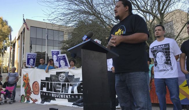 Carlos Garcia, executive director of the immigrant advocate group Puente, addresses a rally of some 40 people outside the U.S. Immigration and Customs Enforcement building in Phoenix, Monday, Feb. 5, 2018. A year ago, immigrant mother Guadalupe Garcia de Rayos was arrested and deported back to her native Mexico. Her case became a cause celebre for advocates who say President Donald Trump&#x27;s immigration policies hurt families. Her attorney is seeking to reopen her case for using a fraudulent ID to get a job, a conviction that made her vulnerable to deportation under Trump after enjoying leniency during the Obama administration. (AP Photo/Anita Snow)