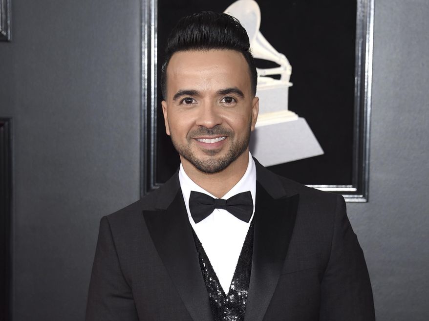 FILe - In this Jan. 28, 2018 file photo, Luis Fonsi arrives at the 60th annual Grammy Awards in New York. The annual BMI Latin Awards will honor Fonsi not only for his mega smash “Despacito” but for the string of hits he’s racked up over two decades. Fonsi is set to receive the BMI President’s Award at the March 20 ceremony in Beverly Hills, Calif. (Photo by Evan Agostini/Invision/AP, File)