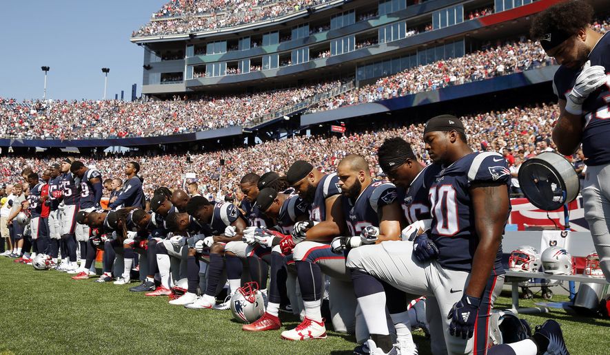 In this Sept. 24, 2017, file photo, several New England Patriots players kneel during the national anthem before an NFL football game against the Houston Texans in Foxborough, Mass. (AP Photo/Michael Dwyer) ** FILE **