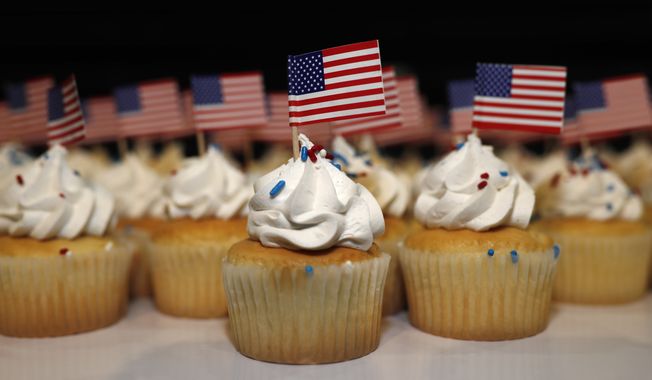 Cupcakes adorned with American flags sit on trays for supporters of Jack Phillips, owner of Masterpiece Cake, after a rally on the campus of a Christian college Wednesday, Nov. 8, 2017, in Lakewood, Colo. The small rally was held to build support for Phillips, who is at the center of a case that will be considered by the U.S. Supreme Court in December. The case may determine if business owners like Phillips are having their right of religious liberty and free expression violated by having to offer their wedding services to same-sex couples. (AP Photo/David Zalubowski) ** FILE **
