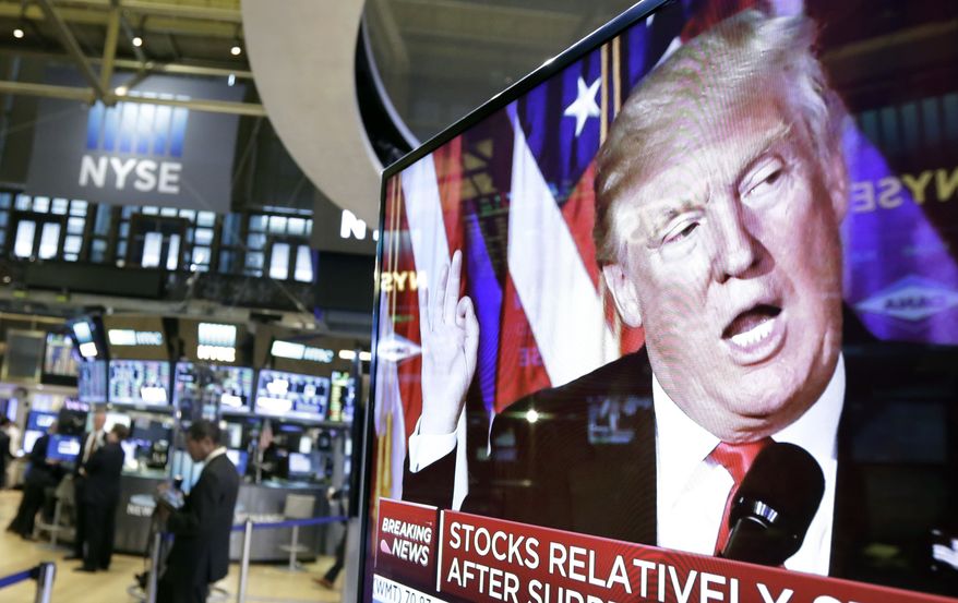 FILE- In this Nov. 9, 2016, file photo an image of President-elect Donald Trump appears on a television screen on the floor of the New York Stock Exchange. President Trump has maintained an uncharacteristic silence since the stock market took a nose dive, notable for a businessman president who regularly points to the rising market as evidence of the success of his presidency and economic policies. (AP Photo/Richard Drew, File)