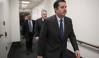 House Intelligence Committee Chairman Devin Nunes, R-Calif., a close ally of President Donald Trump who has become a fierce critic of the FBI and the Justice Department, strides to a GOP conference followed by Rep. Peter King, R-N.Y., also a member of the Intelligence Committee, at the Capitol in Washington, Tuesday, Feb. 6, 2018. Trump last week declassified a document written by the committee&#39;s Republican majority that criticized methods the FBI used to obtain a surveillance warrant on a onetime Trump campaign associate. Trump said the GOP memo showed the FBI and Justice Department conspired against him in the Russia probe. (AP Photo/J. Scott Applewhite)