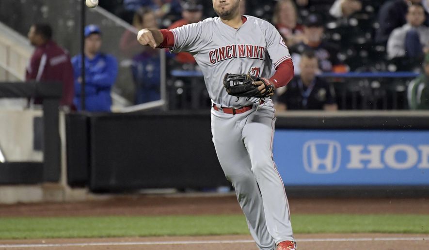 FILE - In this Sept. 7, 2017, file photo, Cincinnati Reds third baseman Eugenio Suarez throws out New York Mets' Kevin Plawecki during a baseball game in New York. The Reds won their salary arbitration case against Suarez, who gets a raise from $595,000 to $3.75 million rather than his request for $4.2 million. (AP Photo/Bill Kostroun, File)
