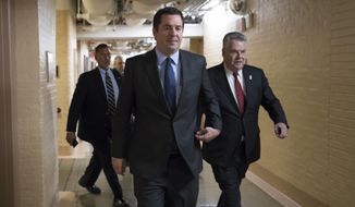 House Intelligence Committee Chairman Devin Nunes, R-Calif., strides to a GOP conference joined at right by Rep. Peter King, R-N.Y., also a member of the Intelligence Committee, at the Capitol in Washington, Tuesday, Feb. 6, 2018.  (AP Photo/J. Scott Applewhite)