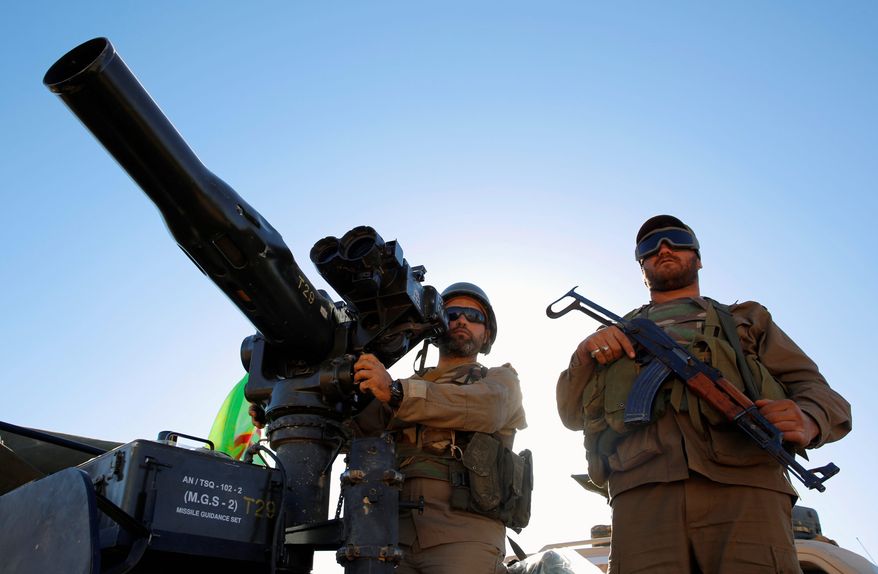 The U.S. government has traced $1.7 billion released to Iran by the Obama administration to terrorists. According to sources, Iran has used the funds to pay Hezbollah, Quds Force and the Islamic Revolutionary Guard Corps. The money supplied to Iran has also been traced back to Iran's backing of Houthi rebels seeking to take power in Yemen.
Hezbollah fighters stand on their army vehicle at the site where clashes erupted between Hezbollah and al-Qaida-linked fighters in Wadi al-Kheil or al-Kheil Valley in the Lebanon-Syria border, Saturday, July 29, 2017. A cease-fire went into effect between the militant Hezbollah group and al-Qaida-linked fighters on Thursday morning as negotiations were underway to reach a deal that would eventually lead to the evacuation of Syrian fighters to the northwestern rebel-held province of Idlib. The truce followed a six-day offensive by Hezbollah and Syrian troops who besieged al-Qaida-linked fighters in a small border area. (AP Photo/Bilal Hussein) (Associated Press)
