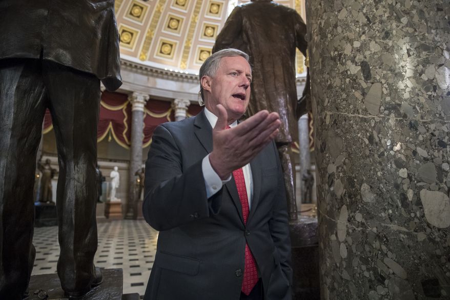Rep. Mark Meadows, R-N.C., chairman of the conservative Freedom Caucus, speaks during a television news interview just before passage of the Republican tax reform bill in the House of Representatives, on Capitol Hill, in Washington, Tuesday, Dec. 19, 2017. (AP Photo/J. Scott Applewhite)