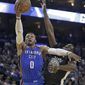 Oklahoma City Thunder&#39;s Russell Westbrook (0) drives to the basket as Golden State Warriors&#39; Draymond Green defends during the first half of an NBA basketball game Tuesday, Feb. 6, 2018, in Oakland, Calif. (AP Photo/Marcio Jose Sanchez)