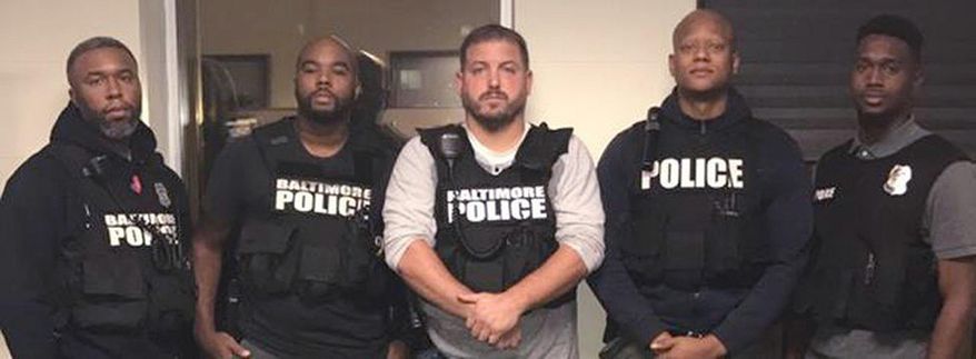 In this October 2016 photo released by the Baltimore police, officers, Det. Evodio Hendrix, Det. Marcus Taylor, Sgt. Wayne Jenkins, Det. Jemell Rayam, Det. Maurice Ward, from left, are seen in Baltimore. Federal prosecutors and defense attorneys are set to make their closing arguments Wednesday, Feb. 7, 2018, in the trial of two Baltimore detectives, Marcus Taylor and Daniel Hersl, fighting racketeering and robbery charges. The case involves one of the worst U.S. police corruption scandals in recent memory. (Baltimore Police Department/The Baltimore Sun via AP)