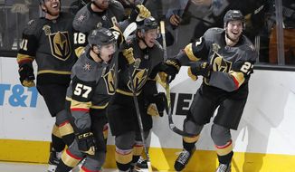 FILE - In this Dec. 19, 2017, file photo, Vegas Golden Knights celebrate after defenseman Shea Theodore, right, scored the game-winning goal against the Tampa Bay Lightning during the third period of an NHL hockey game in Las Vegas. The Golden Knights won, 4-3. The NHL wanted the Vegas Golden Knights to be competitive, but no one expected them to turn up this kind of magic on and off the Las Vegas Strip. Vegas is already the most successful first-year expansion franchise in league history and looks like a serious Stanley Cup contender. (AP Photo/John Locher, File)