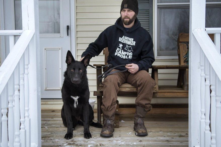 Matt Duckham pulled his mother and his 8-month old German shepherd out of an icy cold pond after his dog accidentally fell in and then his mother fell in trying to save the dog, in Columbia Township, Mich.,on Tuesday, Feb. 6, 2018. (Claire Abendroth/Jackson Citizen Patriot via AP)