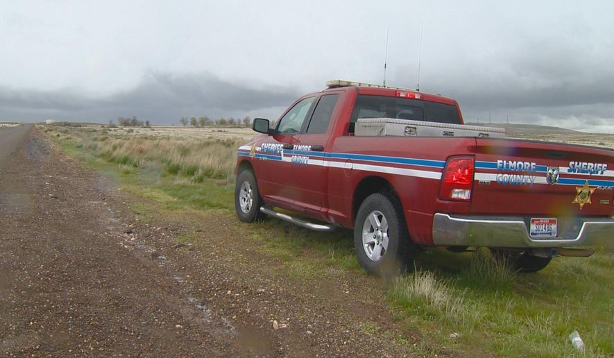 FILE - This April 15, 2017, file video image courtesy of KTVB-TV, shows an Elmore County Sheriff vehicle in the remote area where skeletal remains were found in a badger hole north of Mountain Home, Idaho. The U.S. government says it's working with two Native American tribes to return the 500-year-old, well-preserved bones of a young adult and child found in a southwestern Idaho badger hole to one of the tribes. (Paul Boehlke/ KTVB via AP, File)