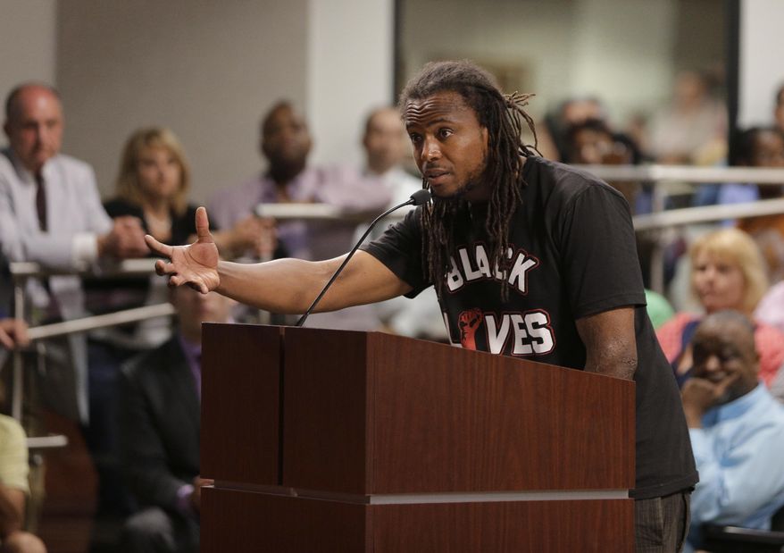 FILE - In this April 9, 2015 file photo, Muhiyidin d'Baha speaks during a meeting with North Charleston city council about the killing of Walter Scott by a North Charleston police officer after a traffic stop in North Charleston, S.C. Muhiyidin d'Baha, whose legal name was Muhiyidin Elamin Moye, was shot in the thigh, Tuesday, Feb. 6, 2018, and died in a hospital, New Orleans police spokesman Beau Tidwell said Wednesday. The circumstances of the shooting were not immediately clear. (AP Photo/Chuck Burton)