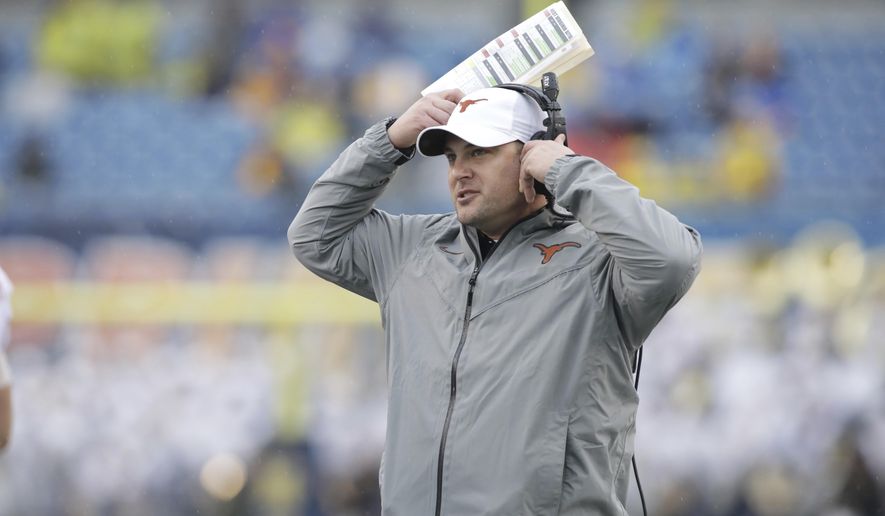 FILE - This Nov. 18, 2017 file photo shows Texas head coach Tom Herman watching his team from the sidelines during the first half of an NCAA college football game against West Virginia in Morgantown, W.Va. Herman and the Texas Longhorns have one of the top signing classes in the nation, not just in the best in the Big 12. After a winning record on the field in Herman’s first season, the Longhorns also made significant strides with the coach’s second recruiting class. Eight more players signed on Wednesday, Feb. 7, 2018 to bolster what was already a strong class with the 19 players added during the early signing period in December. (AP Photo/Raymond Thompson, file)