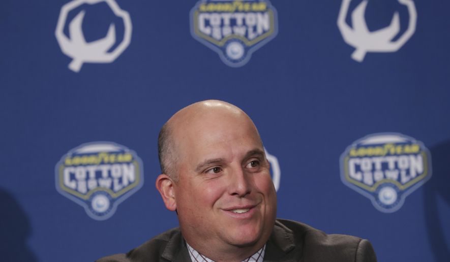 FILE - This Dec. 28, 2017 file photo shows Southern California head coach Clay Helton speaking during a news conference for the Cotton Bowl NCAA college football game against Ohio State in Dallas. Helton lead the way with the Pac-12’s highest-rated recruiting class. Trojans ranked No. 6 nationally after landing a quartet of five-star recruits. Washington and coach Chris Petersen were not far behind, coming in at No. 13. (AP Photo/LM Otero)