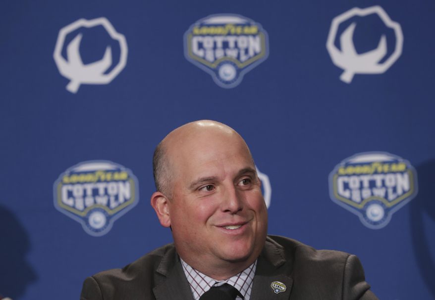 FILE - This Dec. 28, 2017 file photo shows Southern California head coach Clay Helton speaking during a news conference for the Cotton Bowl NCAA college football game against Ohio State in Dallas. Helton lead the way with the Pac-12’s highest-rated recruiting class. Trojans ranked No. 6 nationally after landing a quartet of five-star recruits. Washington and coach Chris Petersen were not far behind, coming in at No. 13. (AP Photo/LM Otero)