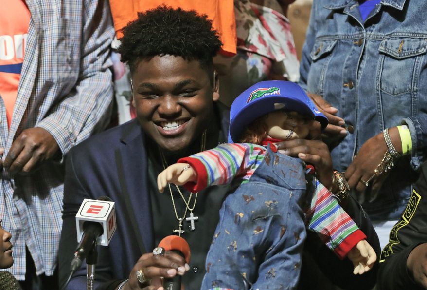Andrew Chatfield, a defensive end from the football team at American Heritage High School, announces he is signing with Florida on national signing day, Wednesday, Feb. 7, 2018, in Plantation, Fla. (AP Photo/Lynne Sladky)