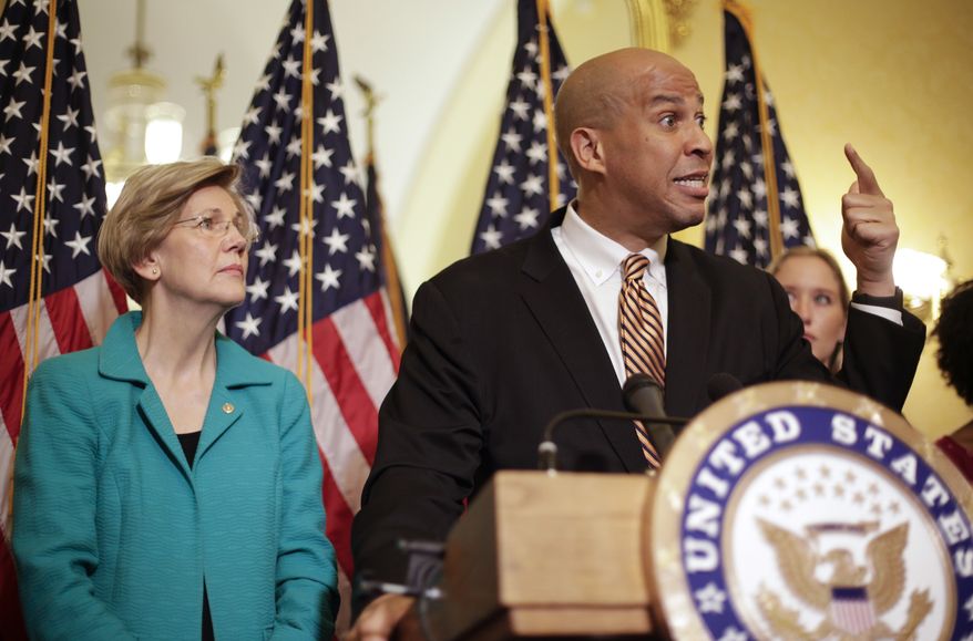 Sen. Cory Booker, D-N.J., and Sen. Elizabeth Warren, D-Mass., participate in a news conference on Capitol Hill in Washington, Tuesday, July 11, 2017, to discuss the introduction of the Dignity for Incarcerated Women Act. The bill helps address some of the unique challenges women face while in prison. (AP Photo/Pablo Martinez Monsivais) ** FILE **

