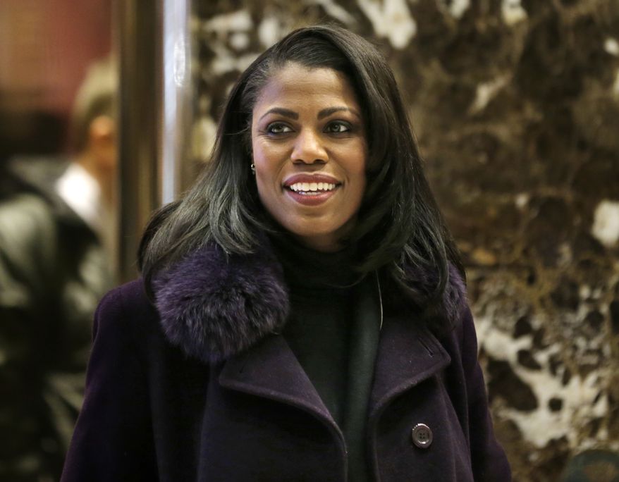Omarosa Manigault smiles at reporters as she walks through the lobby of Trump Tower in New York, Dec. 13, 2016. (AP Photo/Seth Wenig) ** FILE **