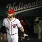 FILE - In this Oct. 12, 2017, file photo, Washington Nationals right fielder Bryce Harper (34) walks in the dugout before Game 5 of baseball&#39;s National League Division Series against the Chicago Cubs, at Nationals Park in Washington. There will be one very important question hovering over Harper and the Nationals throughout spring training and the entire 2018 season: Will this be his last year with the club? (AP Photo/Alex Brandon, File)