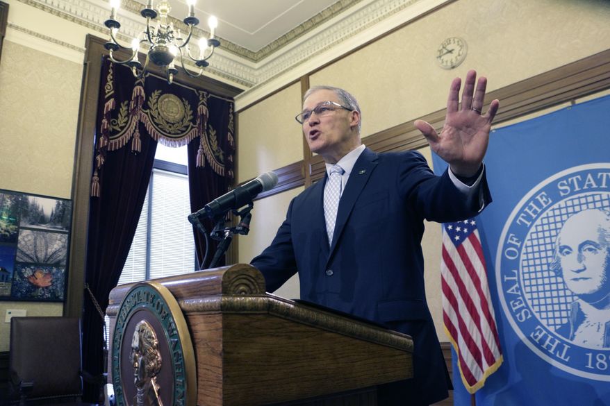 Gov. Jay Inslee talks to the media about bills related to union membership and employee birth dates on Thursday, Feb. 8, 2018, in Olympia, Wash. An ongoing battle between a powerful labor union and a conservative think tank has been playing out in the Legislature as lawmakers consider bills at the center of a yearslong fight. (AP Photo/Rachel La Corte)